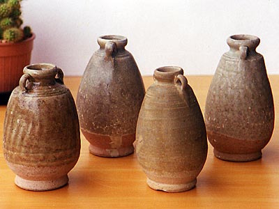 A collection of green glazed ceramic bottle vases with lug handles - Sukhothai ceramics