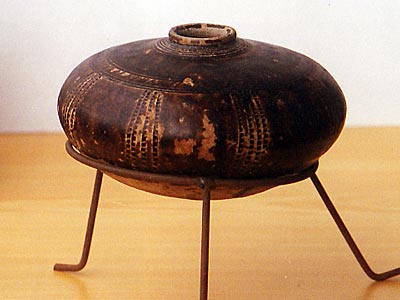 A glazed ceramic honey pot incised with concentric rings. Khmer, Bayon period